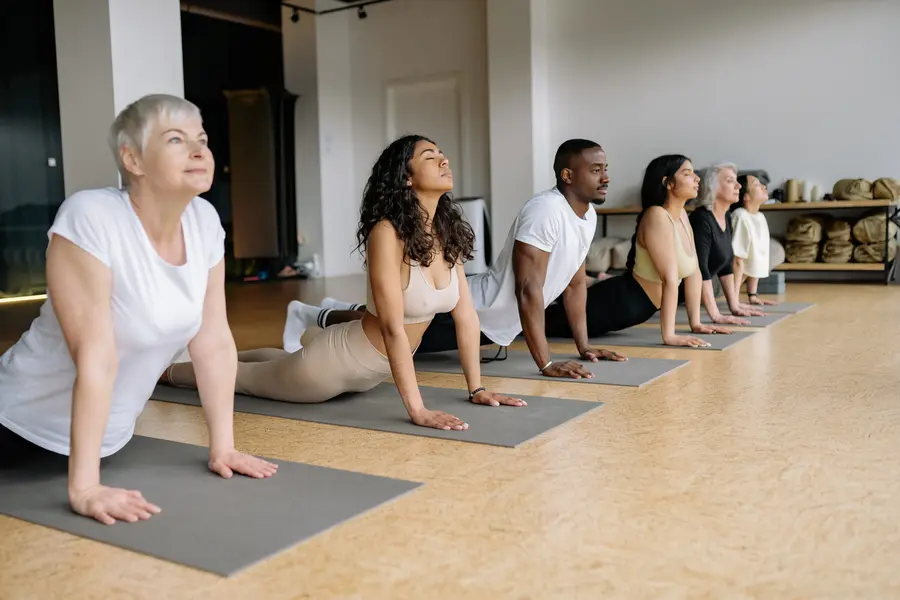 yoga students practising upward facing dog pose